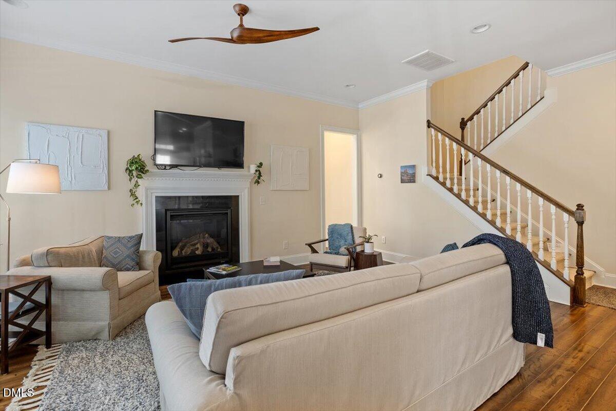 780 Fallon Grove Way Raleigh, NC 27608 - Photo 9 of 40 a living room with furniture and a fireplace