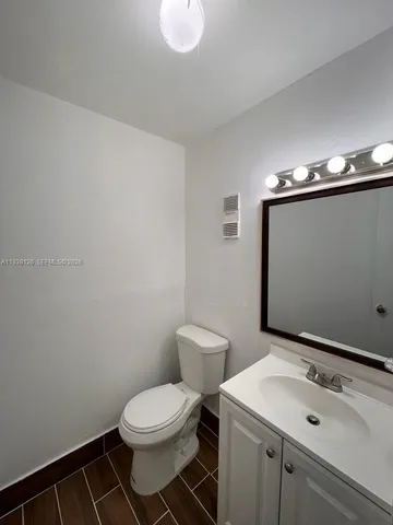 a bathroom with a sink a toilet and mirror