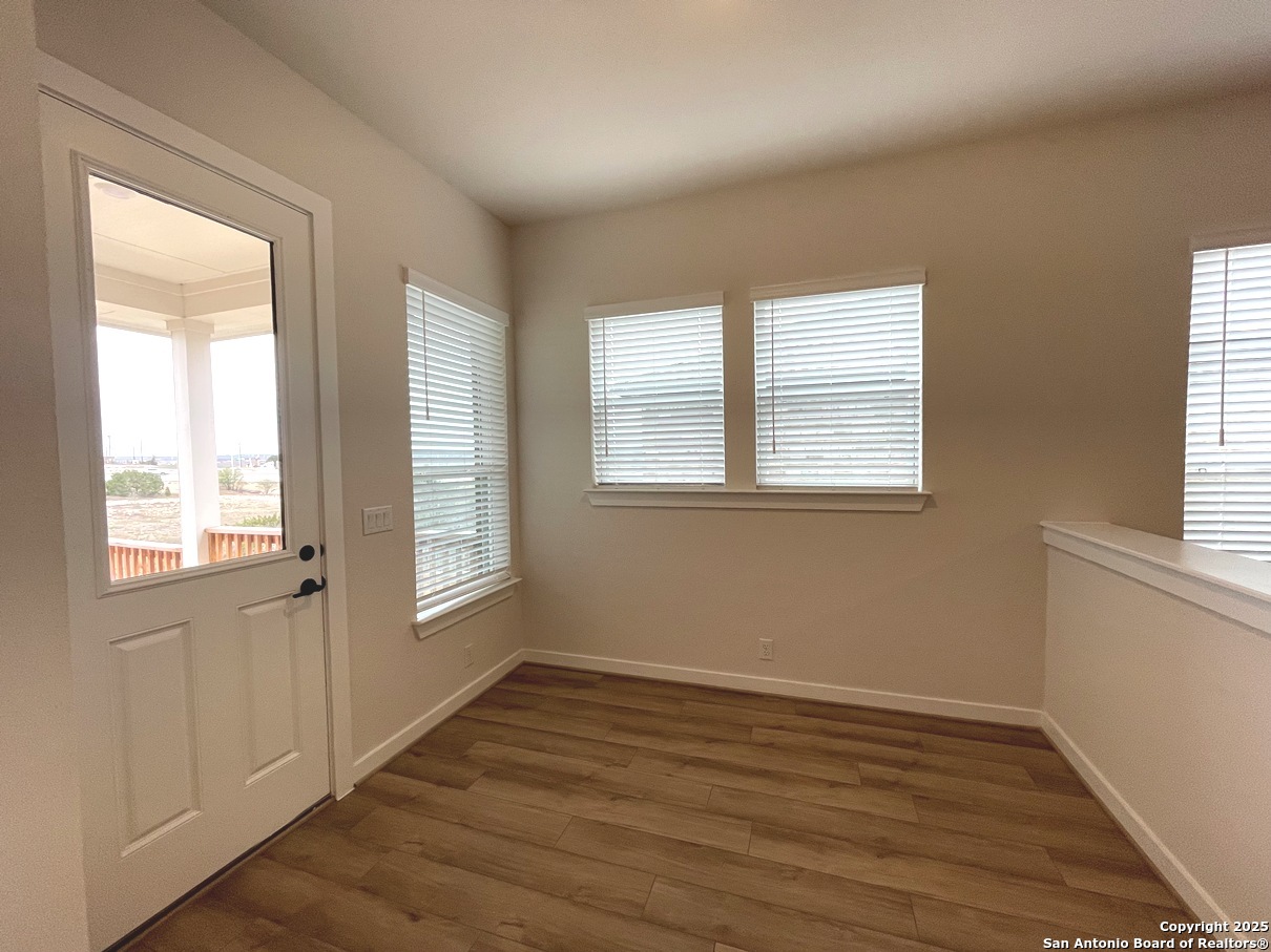116 Radnor Road New Braunfels, TX 78130 - Photo 21 of 26 a view of an empty room with wooden floor and a window