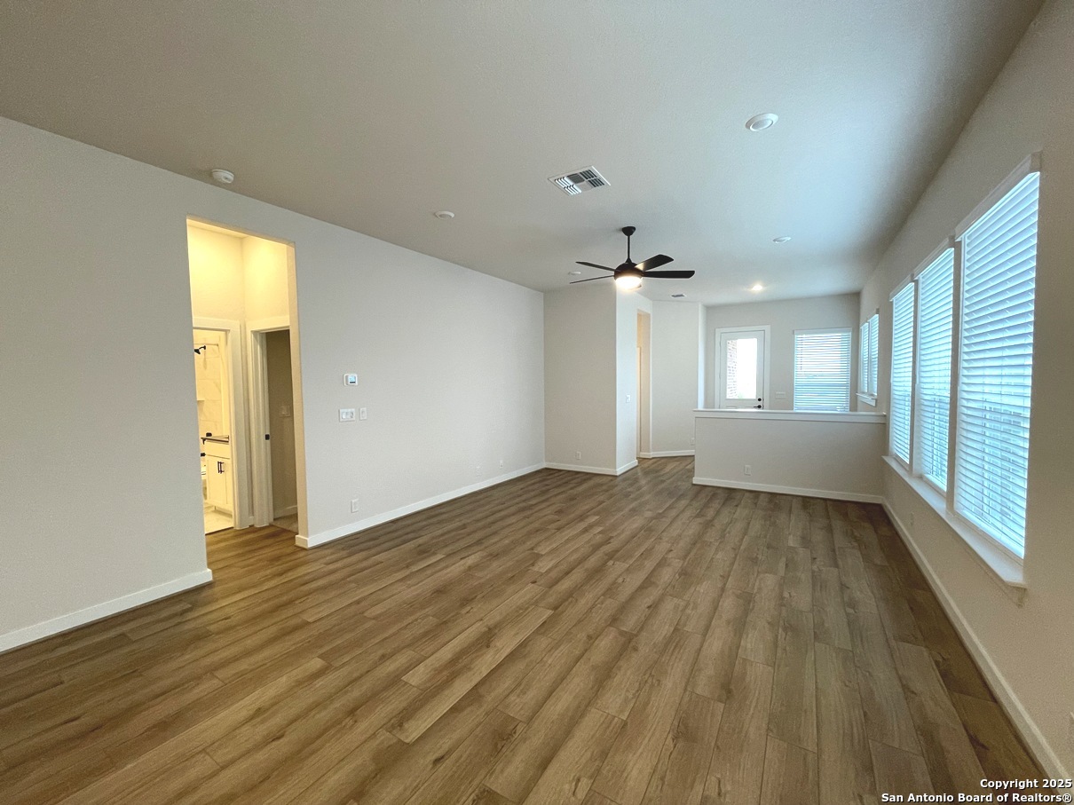 116 Radnor Road New Braunfels, TX 78130 - Photo 4 of 26 a view of empty room with wooden floor and fan