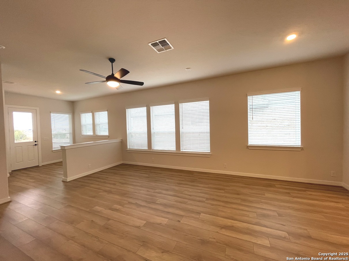 116 Radnor Road New Braunfels, TX 78130 - Photo 5 of 26 a view of an empty room with wooden floor and a window