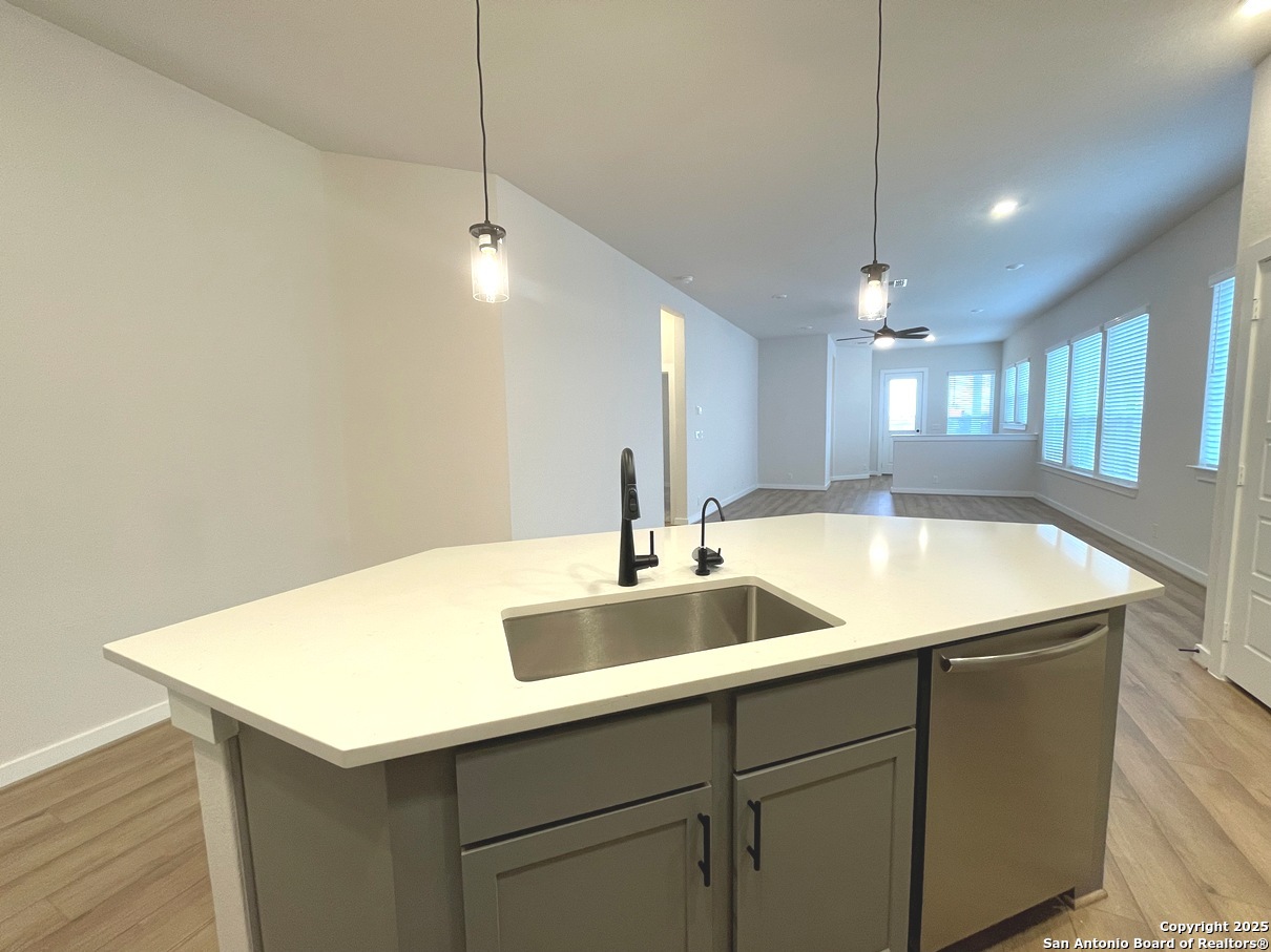 116 Radnor Road New Braunfels, TX 78130 - Photo 7 of 26 a kitchen with a sink a counter space and a refrigerator