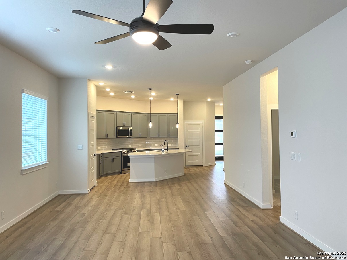 116 Radnor Road New Braunfels, TX 78130 - Photo 9 of 26 a large kitchen with a lot of counter space and wooden floor