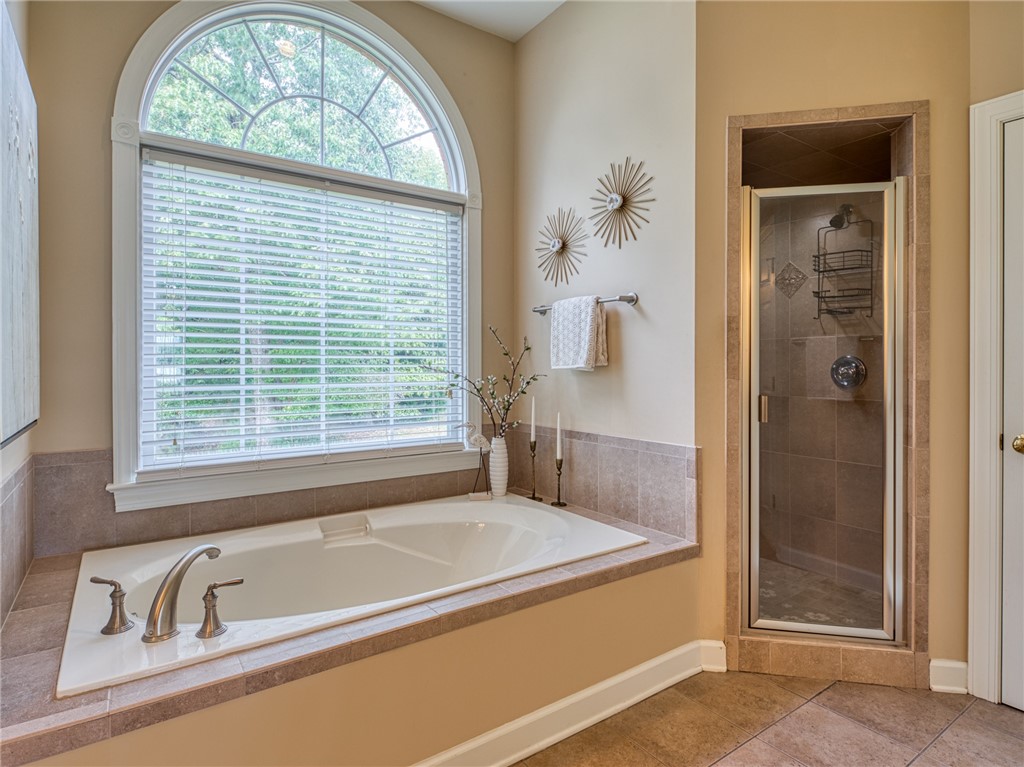 7914 O Neil Road Gloucester, VA 23061 - Photo 21 of 47 Bathroom featuring a stall shower, a garden tub, and tile patterned floors