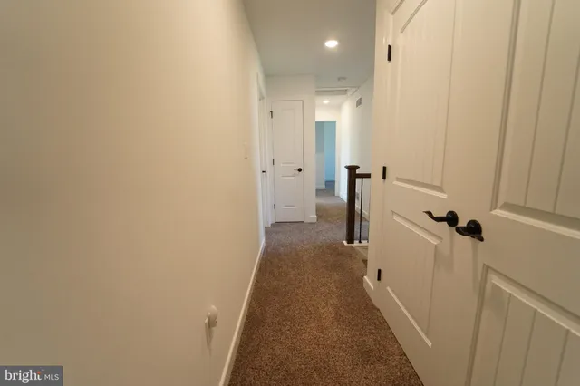 a view of staircase with white walls