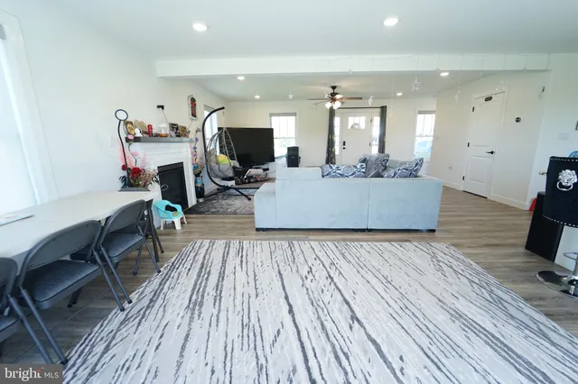 a living room with furniture and kitchen view