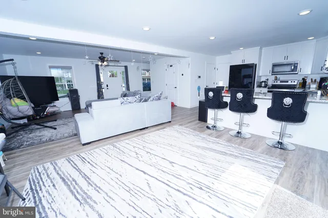 a living room with furniture and kitchen view