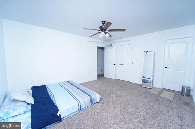a bathroom with a granite countertop sink a large mirror and a bathtub