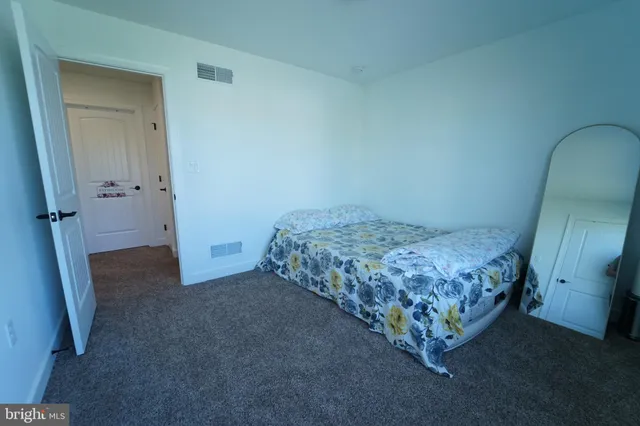 a bathroom with a granite countertop toilet sink and mirror
