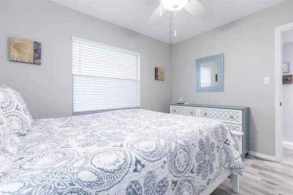 a bedroom with a large bed and a chandelier