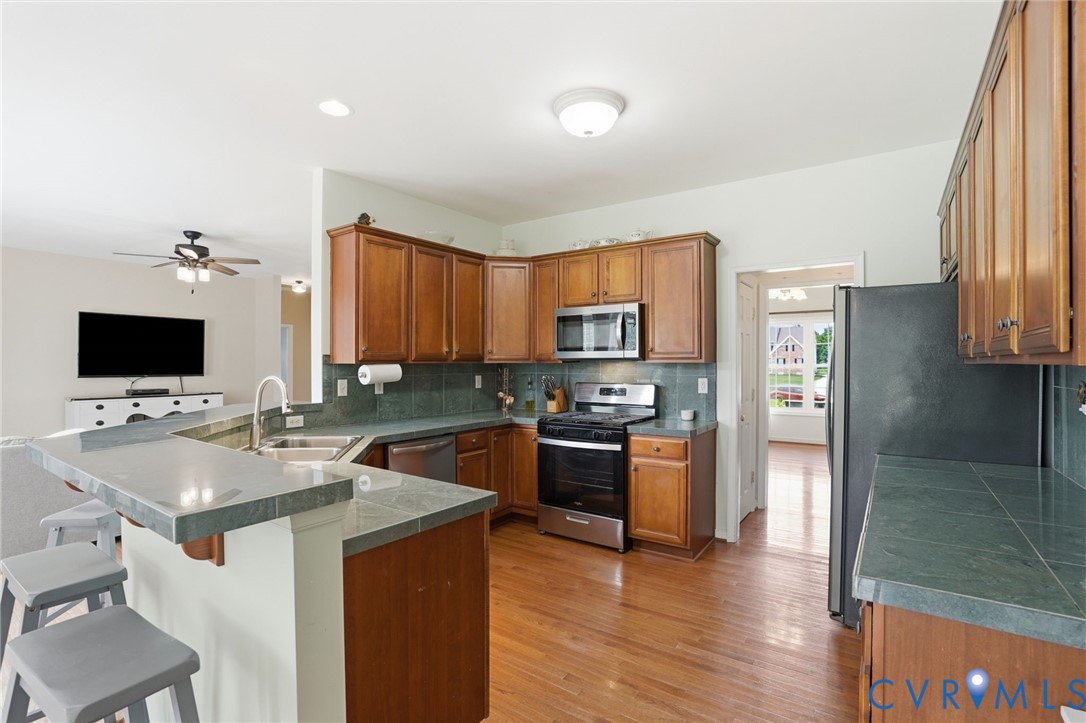 5305 Wellington Ridge Road Richmond, VA 23231 - Photo 18 of 67 Kitchen featuring wood-finish cabinetry, stainless