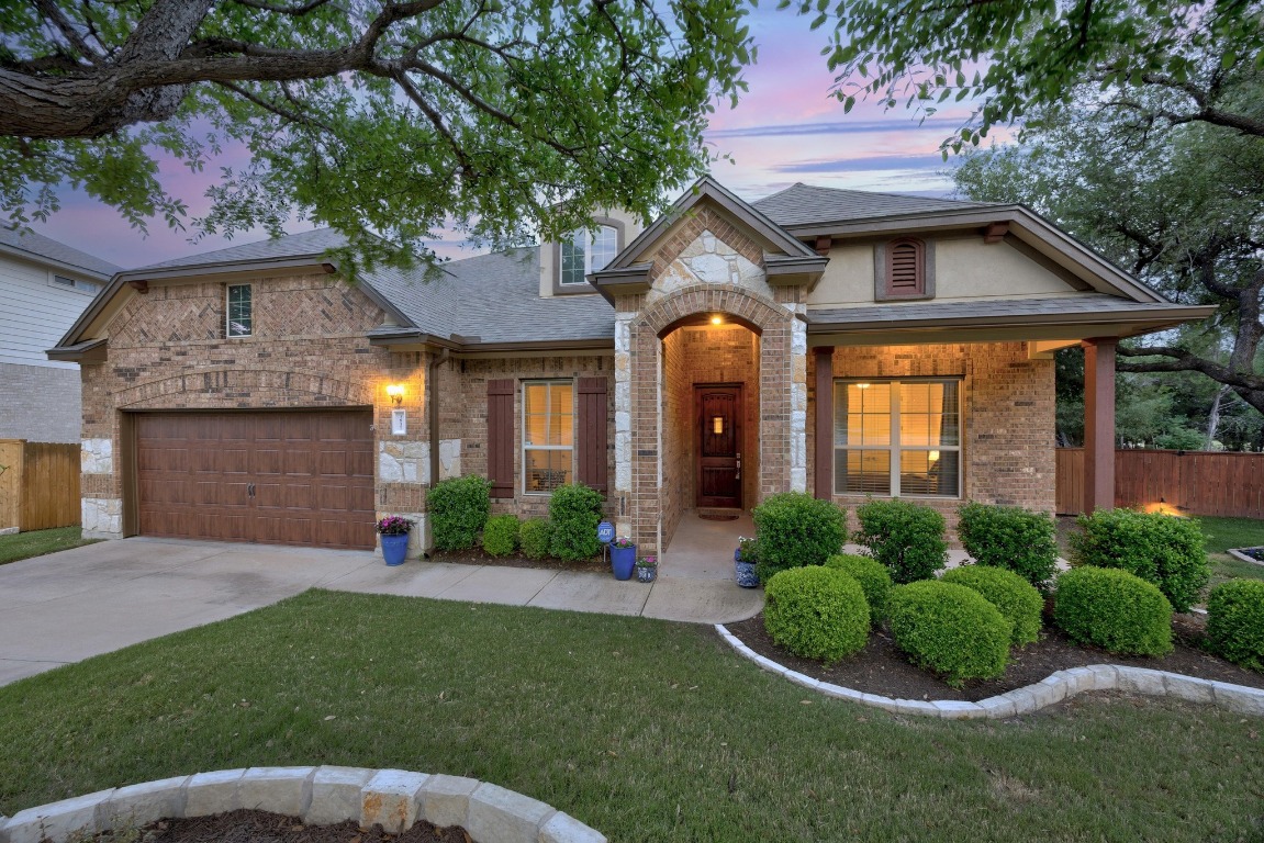a front view of a house with a yard and garage