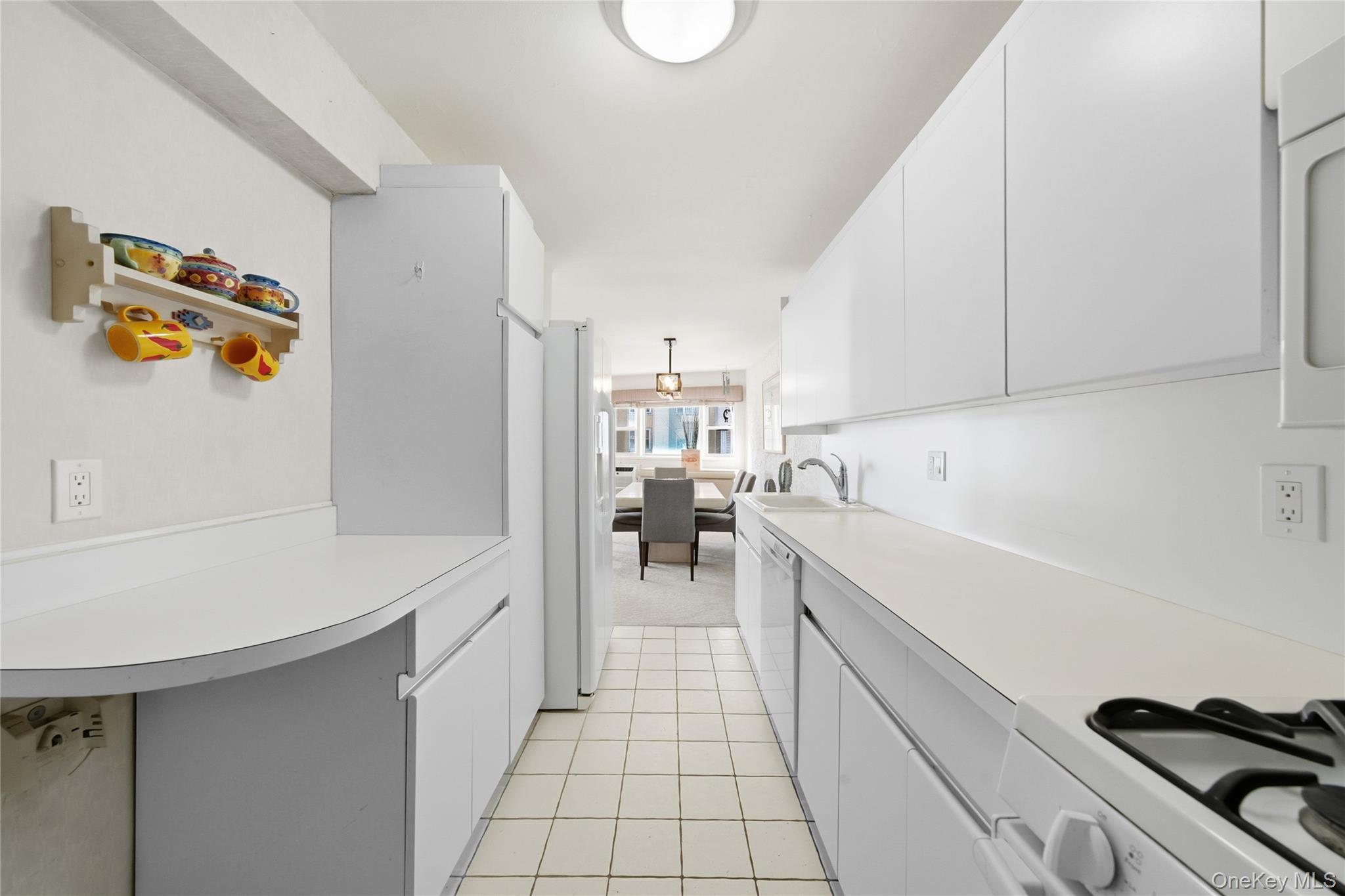 750 Shore Road, Unit 3O Long Beach, NY 11561 - Photo 11 of 23 a kitchen with a sink and appliances