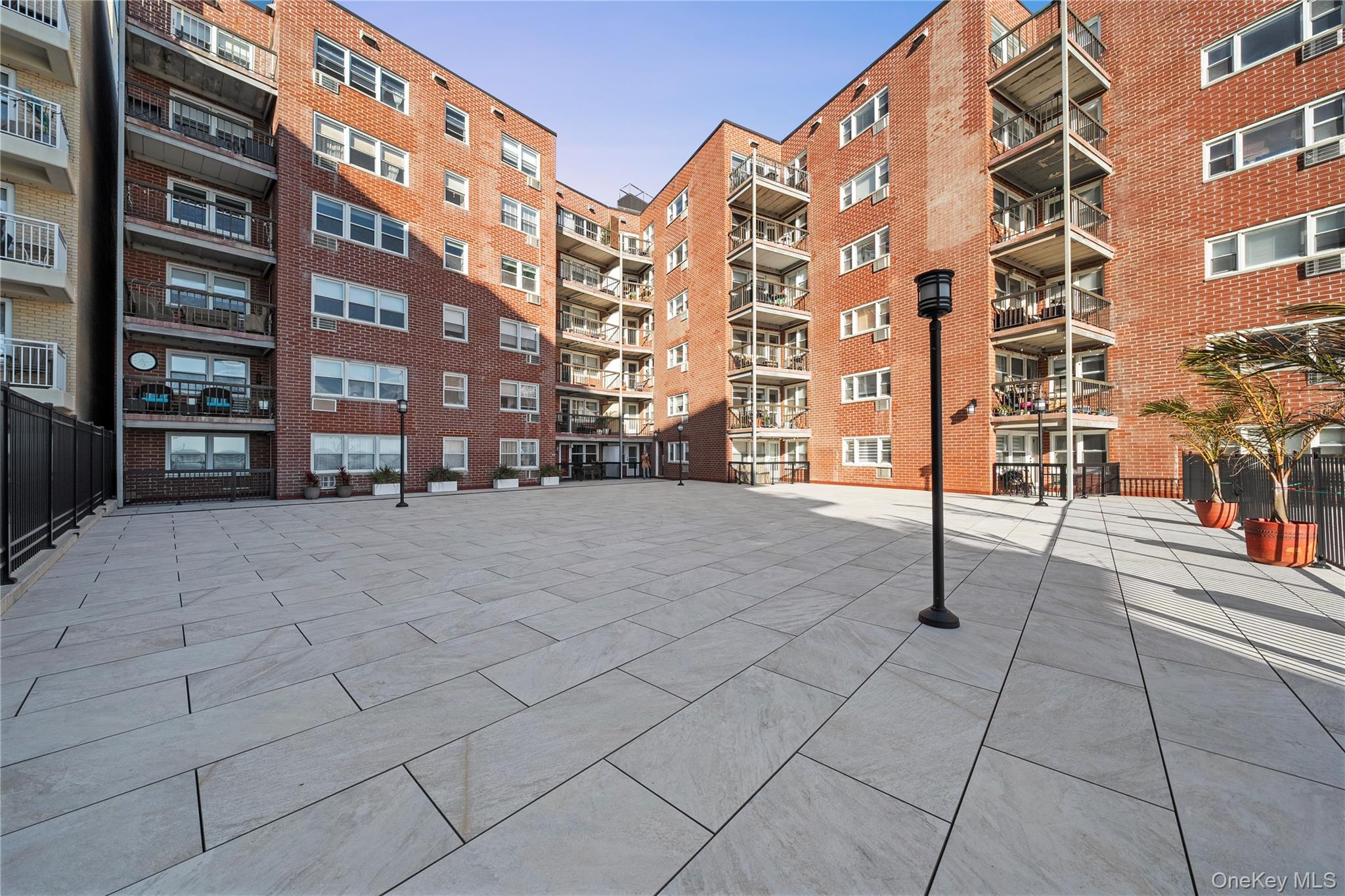750 Shore Road, Unit 3O Long Beach, NY 11561 - Photo 18 of 23 a view of tall buildings with a yard