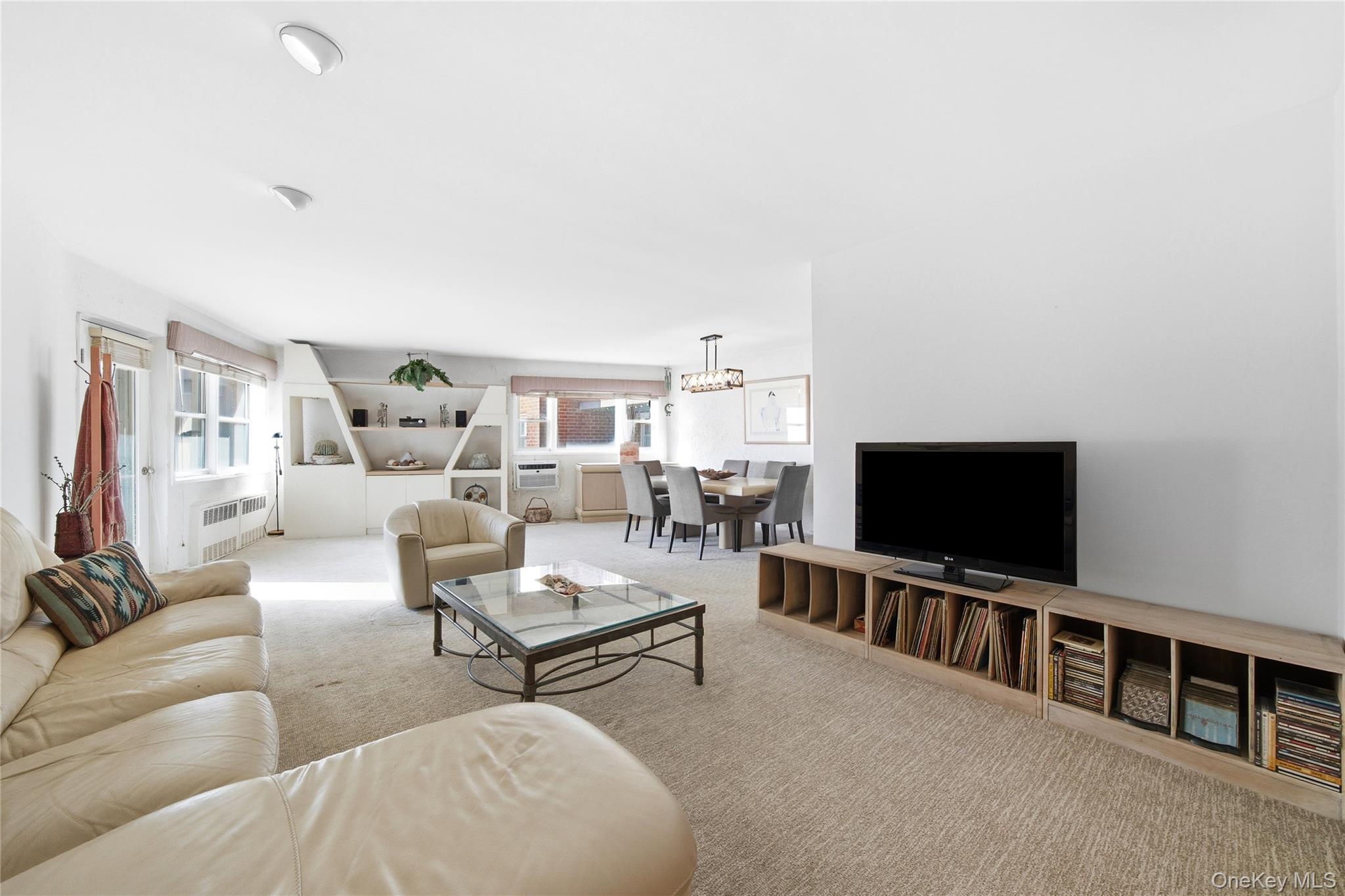 750 Shore Road, Unit 3O Long Beach, NY 11561 - Photo 3 of 23 a living room with furniture and a flat screen tv