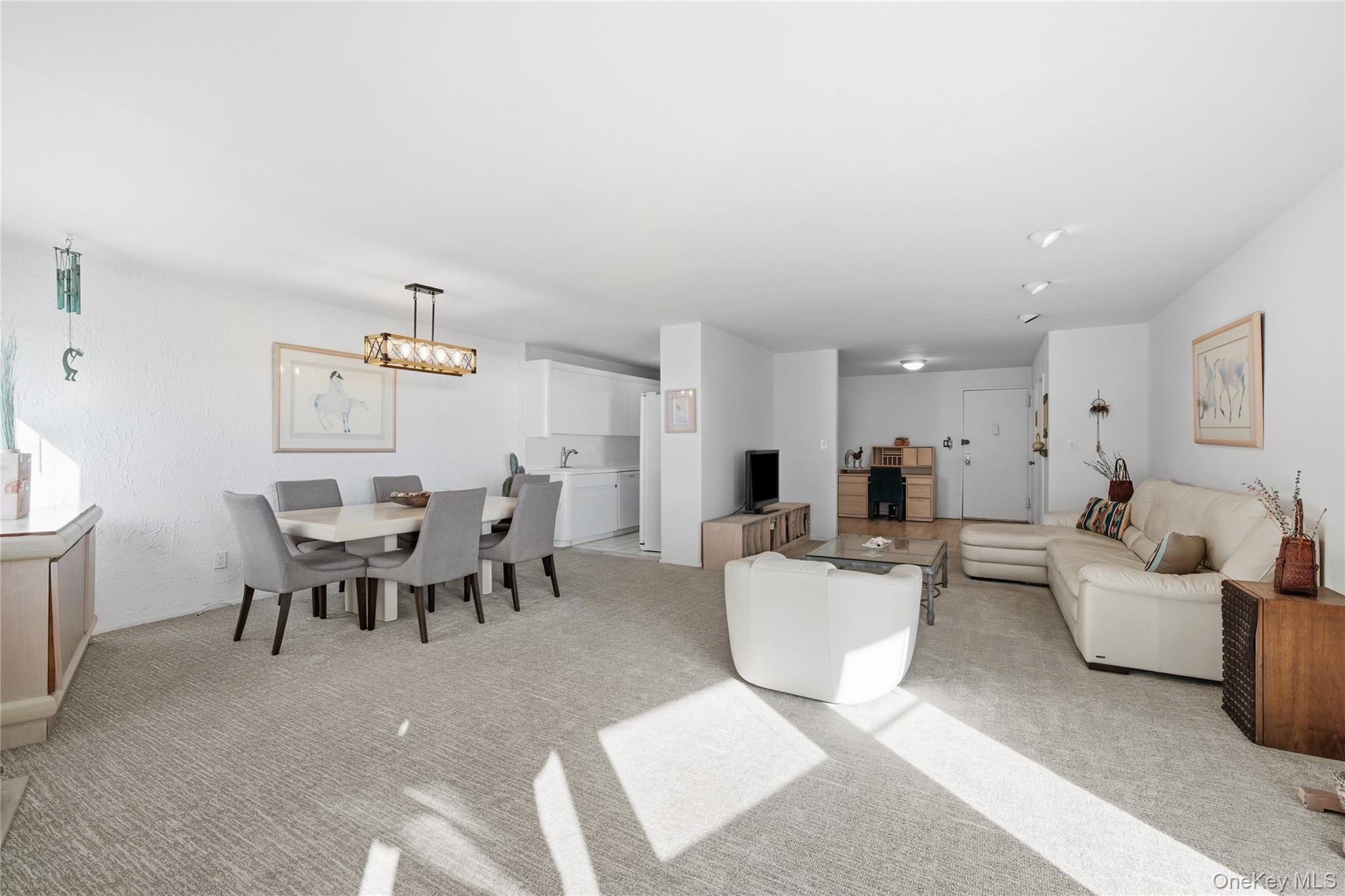 750 Shore Road, Unit 3O Long Beach, NY 11561 - Photo 4 of 23 a living room with furniture a dining table and kitchen view