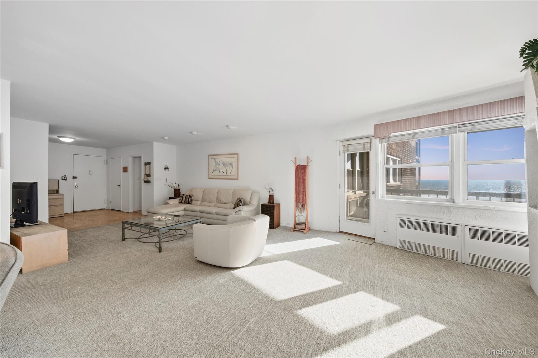 750 Shore Road, Unit 3O Long Beach, NY 11561 - Photo 8 of 23 a living room with furniture and a large window