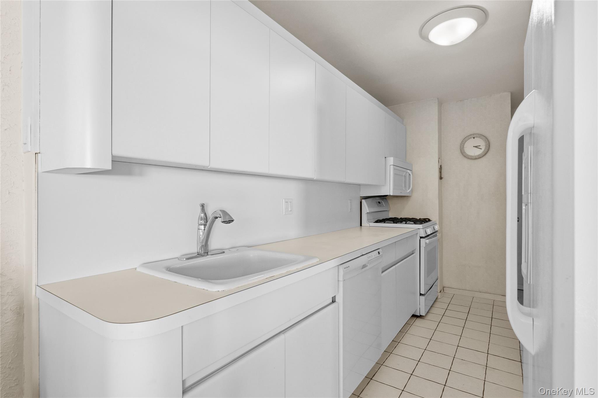 750 Shore Road, Unit 3O Long Beach, NY 11561 - Photo 10 of 23 a kitchen with a sink dishwasher and a refrigerator