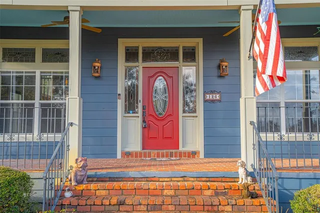a view of a hallway with wooden floor and a chandelier