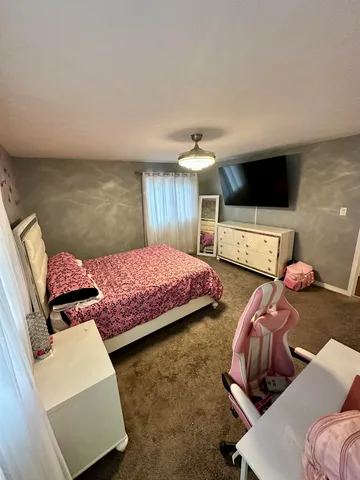a bedroom with two beds and a couch