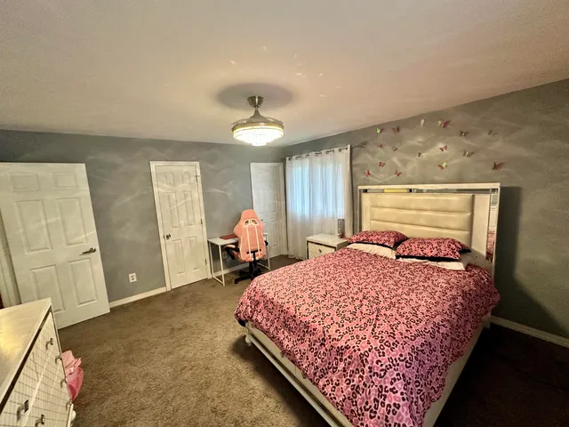 a bed sitting in a bedroom next to a window