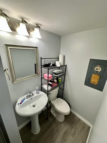 a bathroom with a toilet sink and mirror