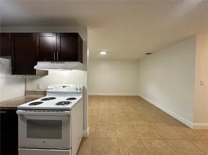 a kitchen with a stove a sink and a refrigerator