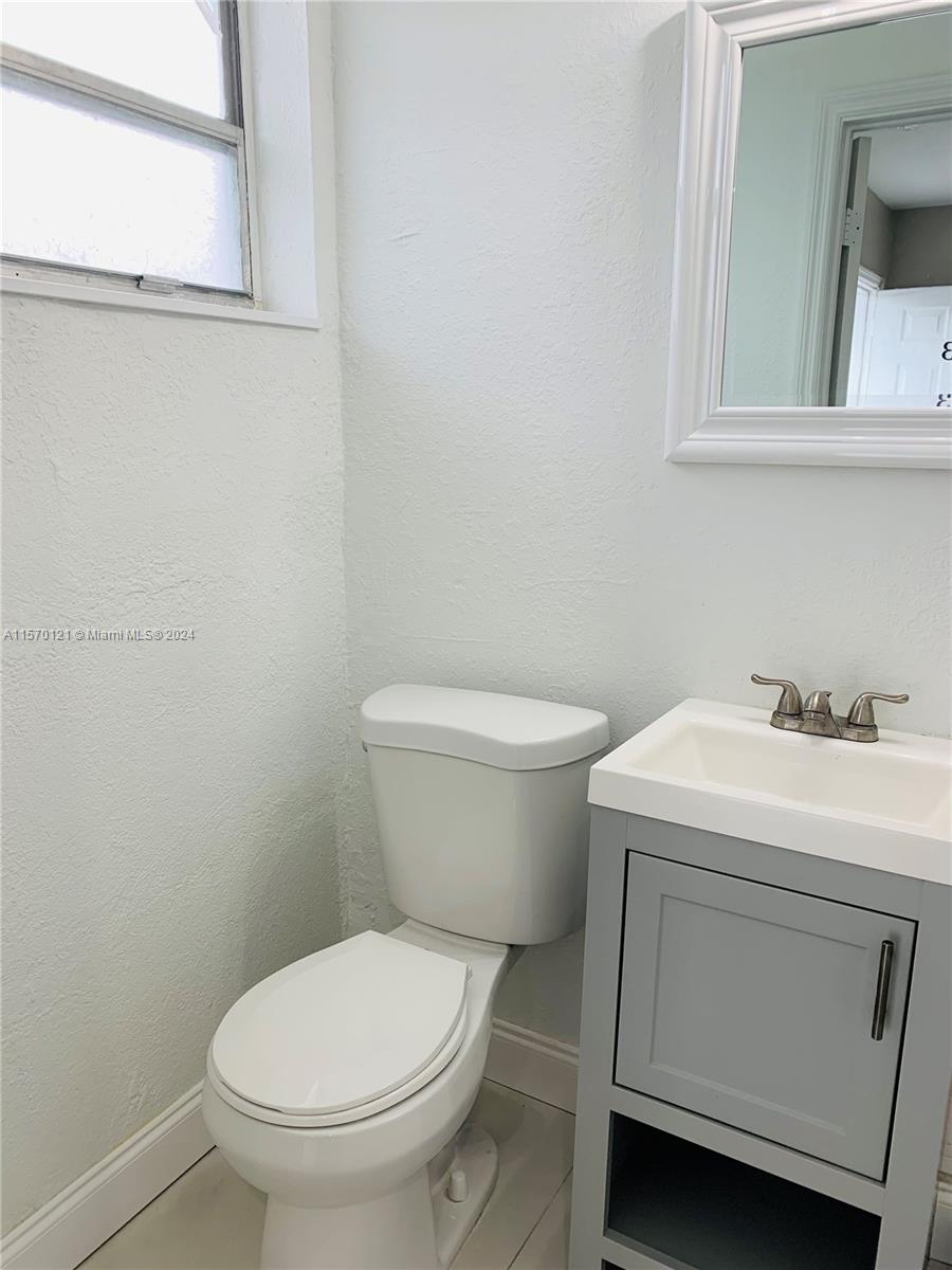 1265 Southwest 6th Street, Unit 13 Miami, FL 33135 - Photo 6 of 7 a white toilet sitting next to a bathroom sink
