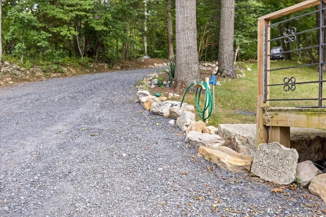 a kitchen with stainless steel appliances granite countertop a sink dishwasher stove and cabinets with wooden floor