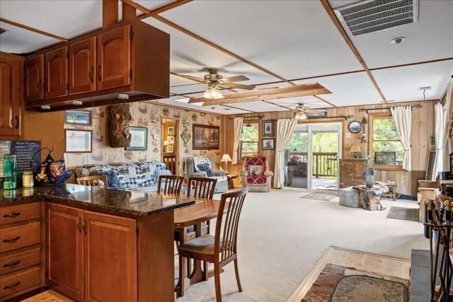 a living room with furniture and a ceiling fan