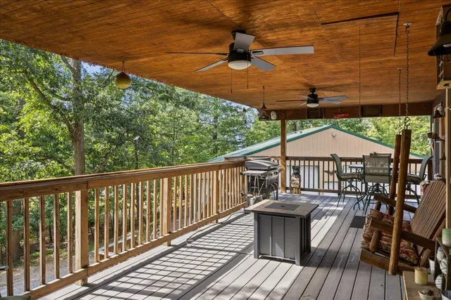 a view of a porch with furniture and a yard