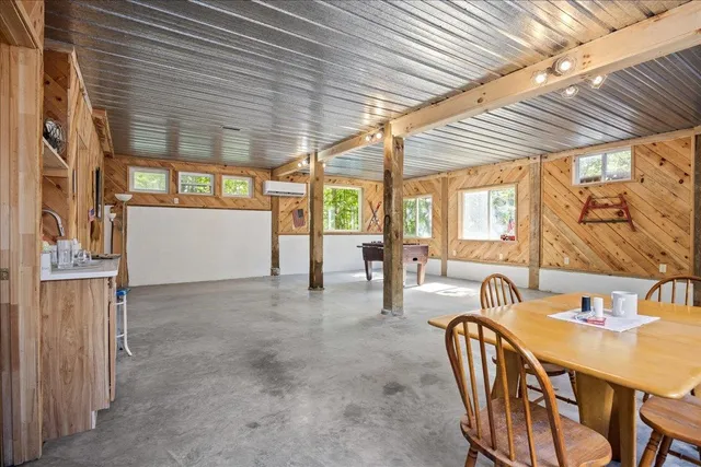 a view of a patio with a table chairs and a backyard