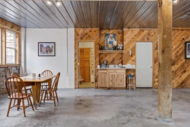 a view of a yard with porch and wooden fence