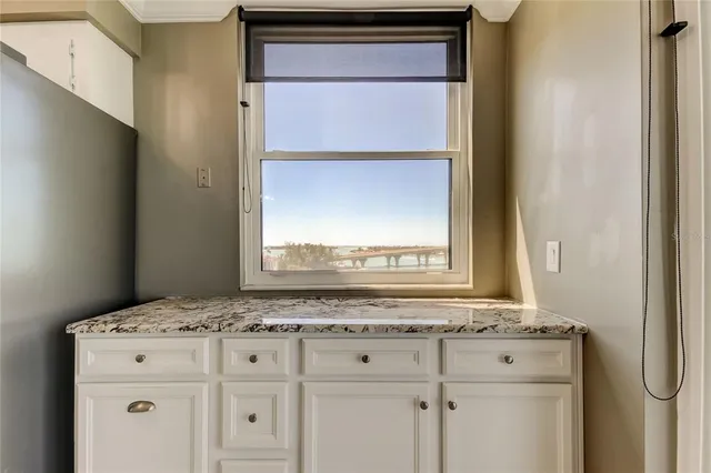 a view of a kitchen with a sink and cabinets