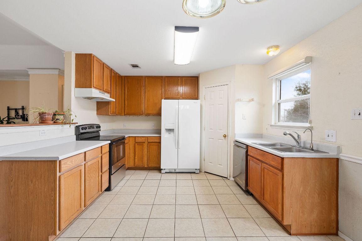 112 Amherst Court Kyle, TX 78640 - Photo 11 of 38 a kitchen with a stove top oven sink and cabinets