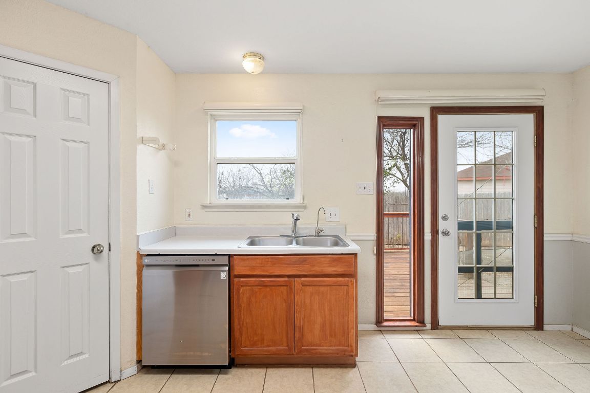 112 Amherst Court Kyle, TX 78640 - Photo 12 of 38 a view of a kitchen with dishwasher and wooden floor