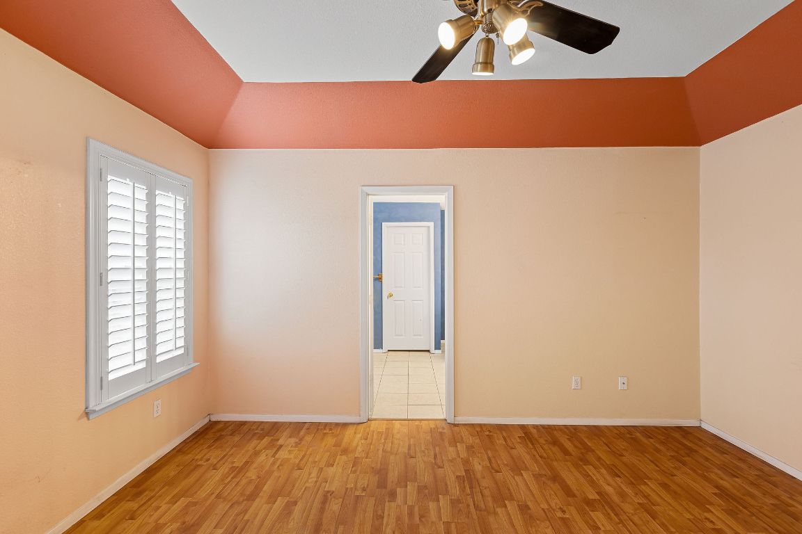 112 Amherst Court Kyle, TX 78640 - Photo 14 of 38 an empty room with windows and cabinet