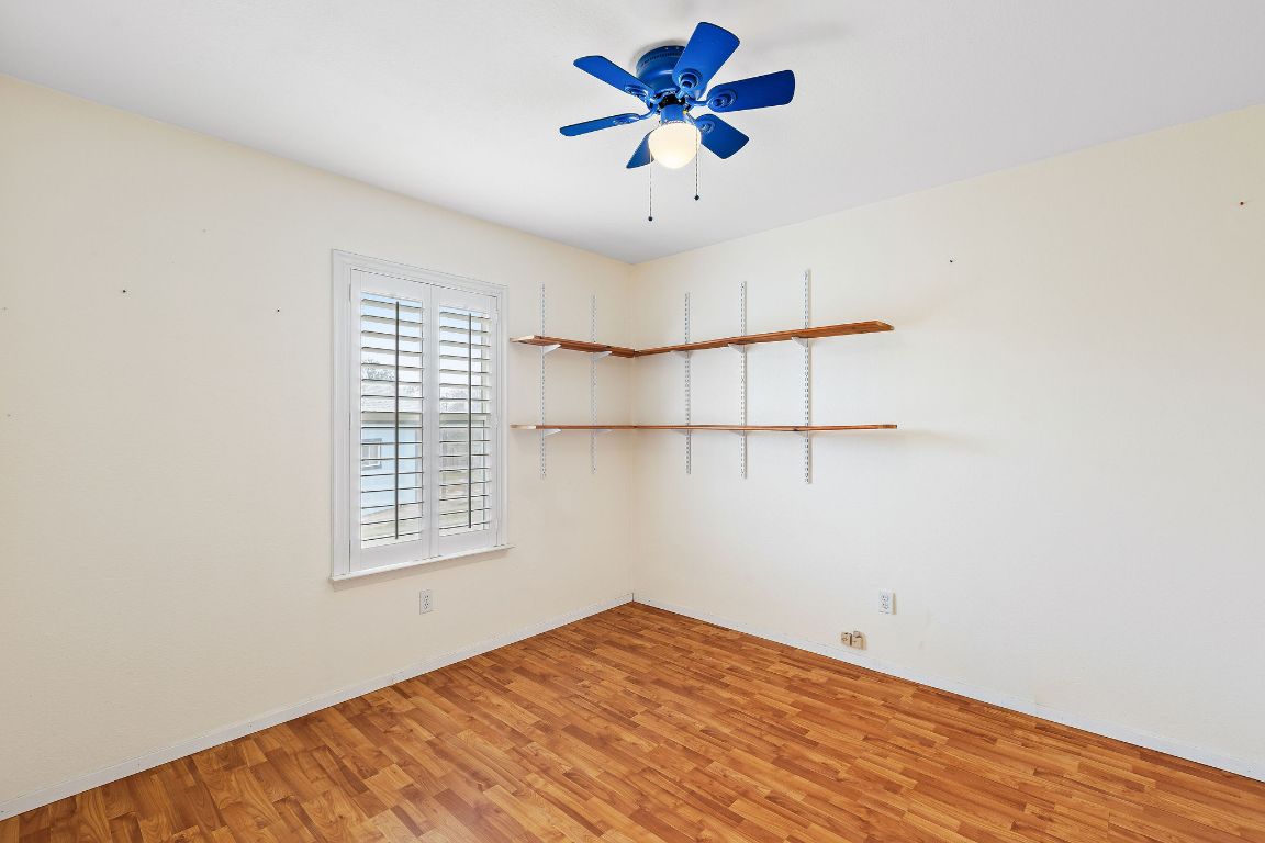 112 Amherst Court Kyle, TX 78640 - Photo 22 of 38 a view of a big room with wooden floor and a chandelier fan