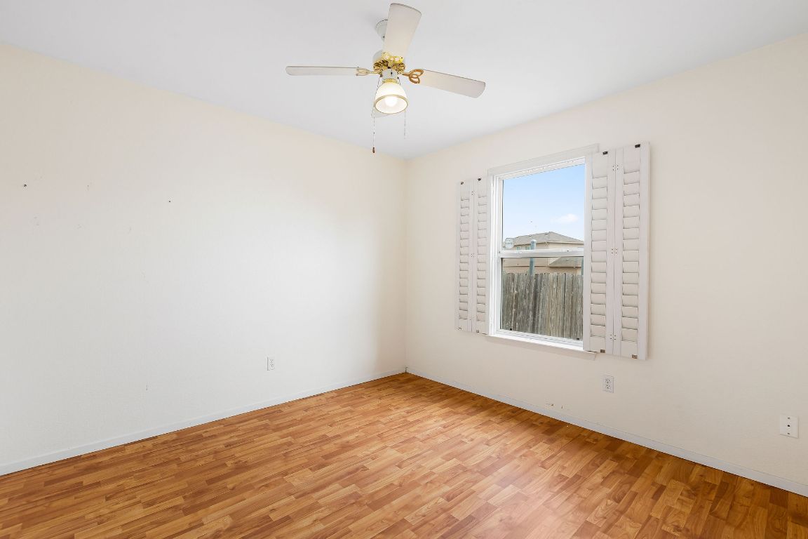 112 Amherst Court Kyle, TX 78640 - Photo 26 of 38 an empty room with a window and ceiling fan