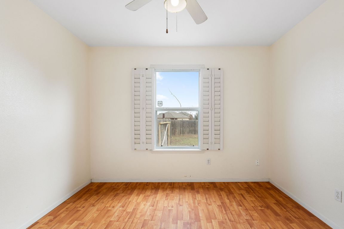 112 Amherst Court Kyle, TX 78640 - Photo 27 of 38 an empty room with a window and wooden floor
