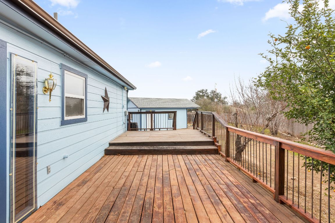 112 Amherst Court Kyle, TX 78640 - Photo 32 of 38 a view of wooden balcony and two chairs