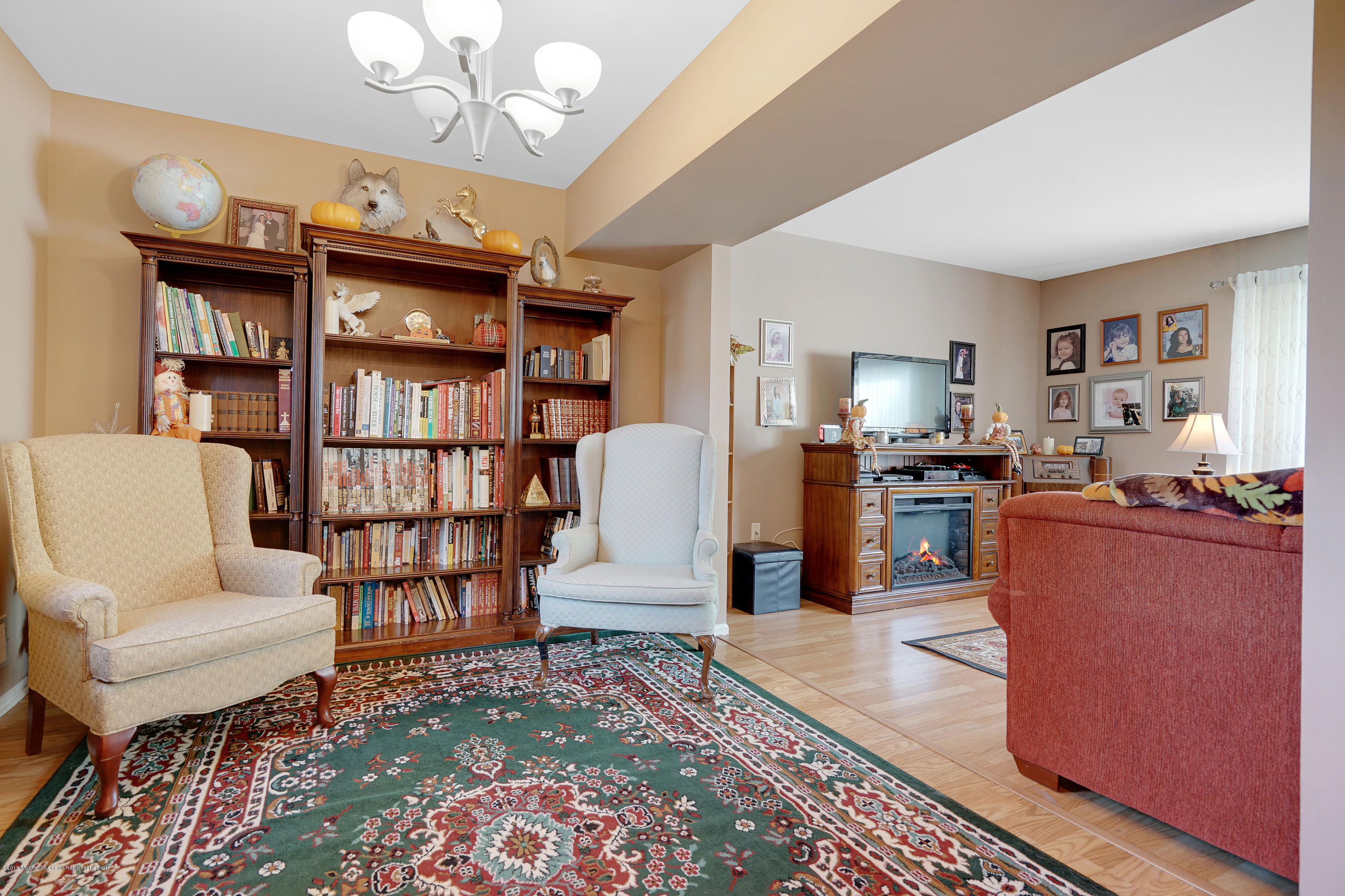 123 Reflection Road Toms River, NJ 08753 - Photo 18 of 41 a living room with furniture a rug and a bookshelf