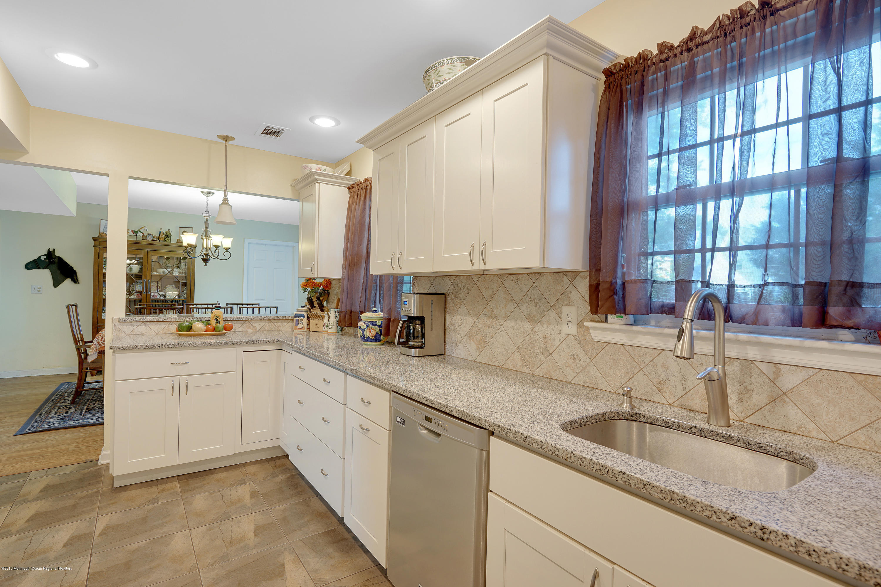 123 Reflection Road Toms River, NJ 08753 - Photo 20 of 41 a kitchen with granite countertop a sink and white cabinets