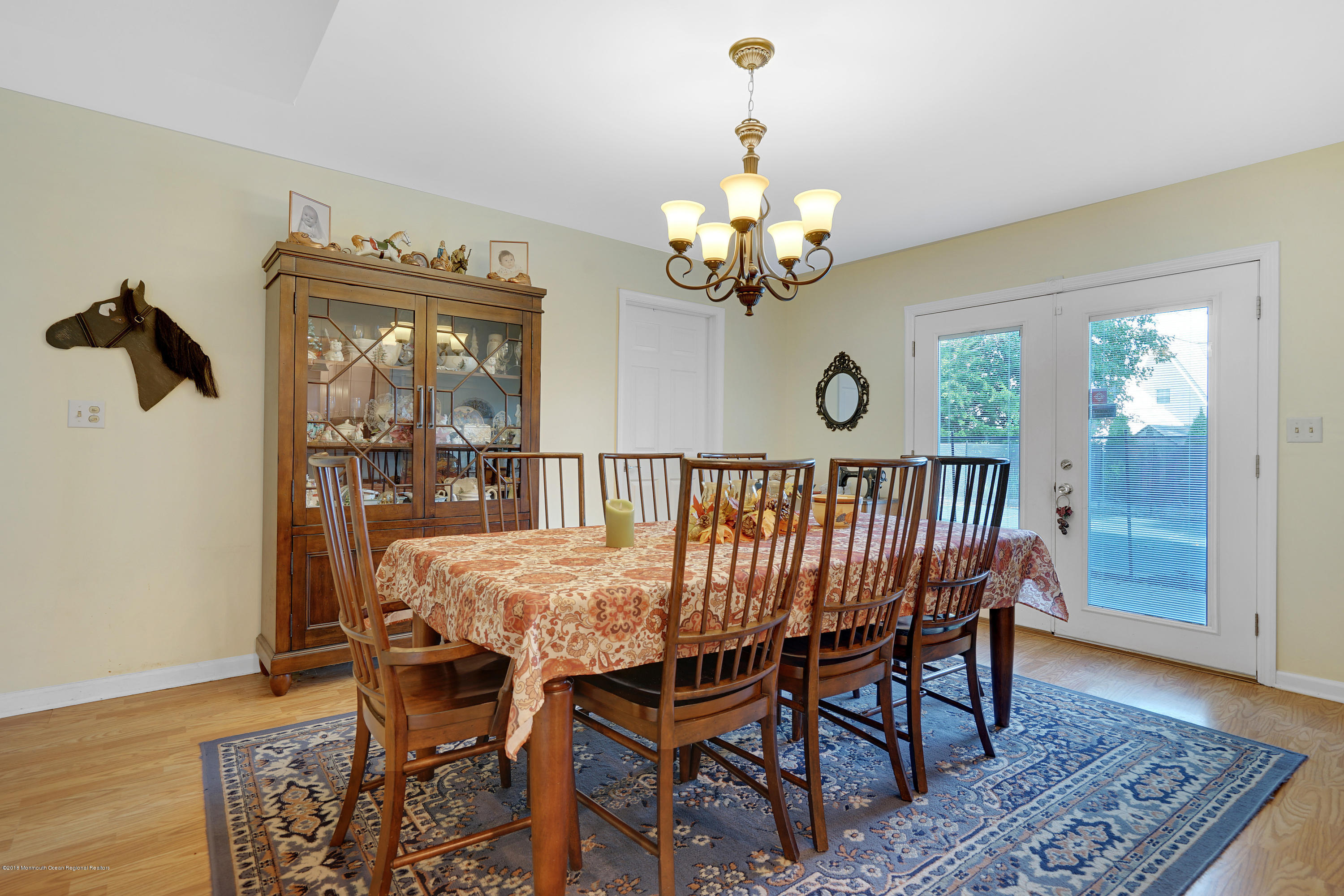 123 Reflection Road Toms River, NJ 08753 - Photo 23 of 41 a view of a dining room with furniture wooden floor and a chandelier