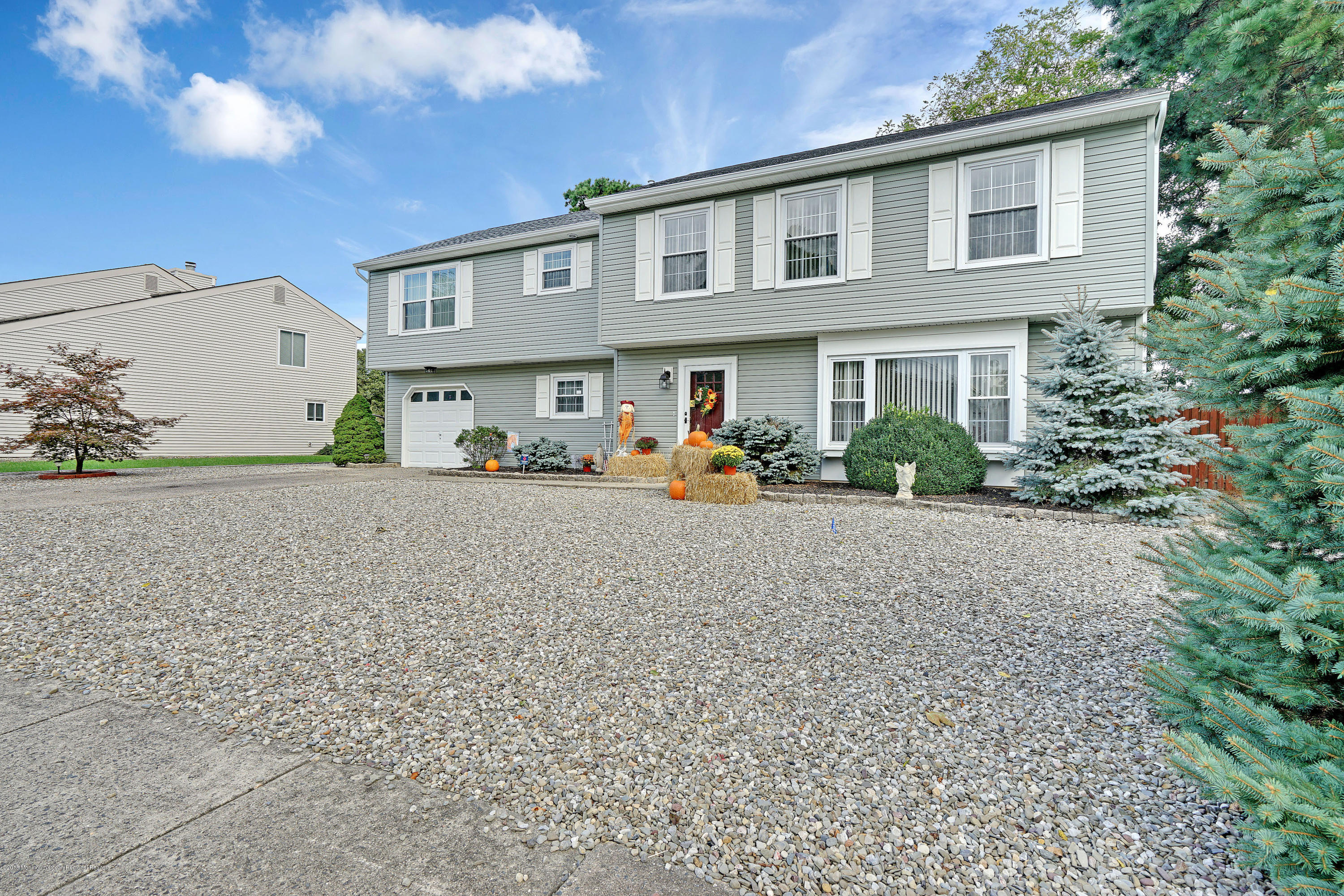123 Reflection Road Toms River, NJ 08753 - Photo 5 of 41 a front view of a house with outdoor seating