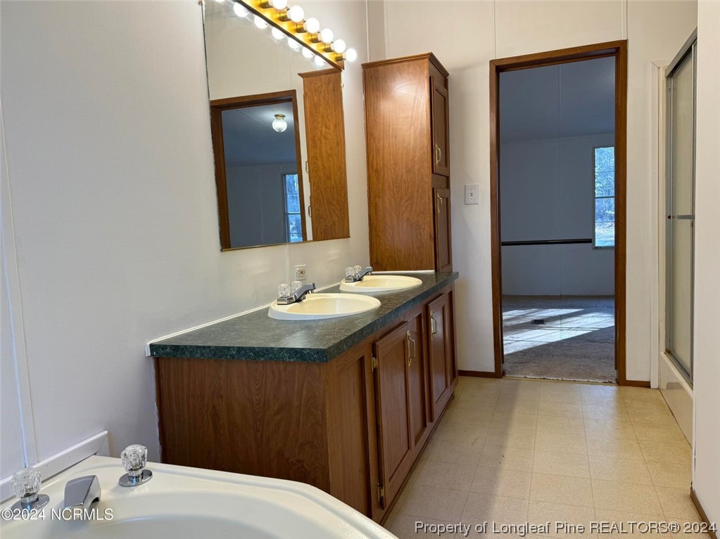 2352 County Line Road Cameron, NC 28326 - Photo 20 of 38 a bathroom with a sink and a mirror
