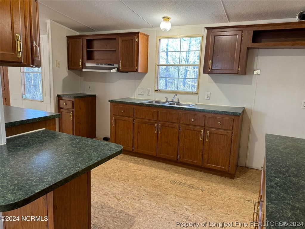 2352 County Line Road Cameron, NC 28326 - Photo 25 of 38 a kitchen with stainless steel appliances granite countertop a stove a sink and a microwave