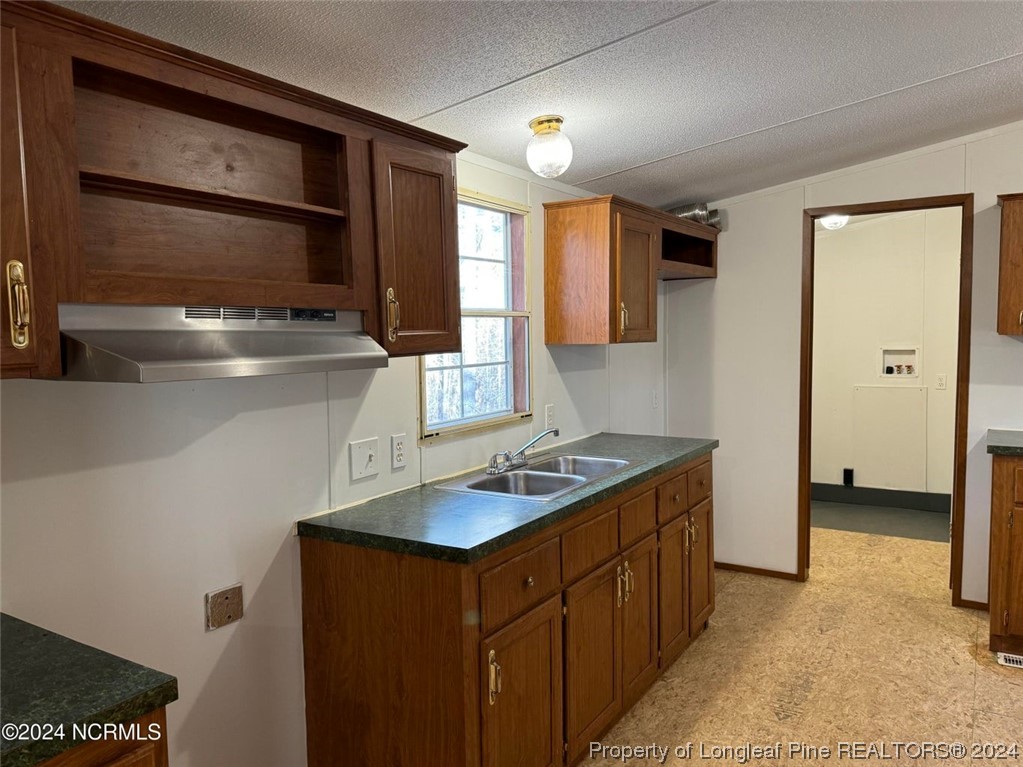 2352 County Line Road Cameron, NC 28326 - Photo 28 of 38 a kitchen with a refrigerator and a sink