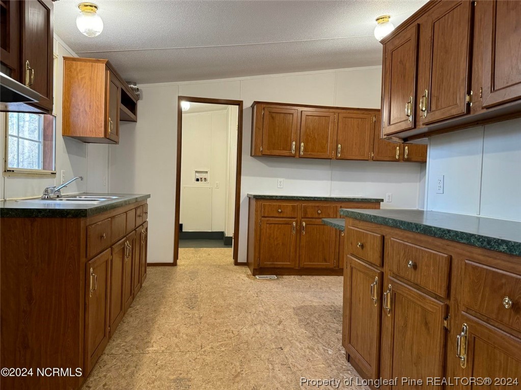 2352 County Line Road Cameron, NC 28326 - Photo 29 of 38 a kitchen with stainless steel appliances granite countertop a sink stove and cabinets