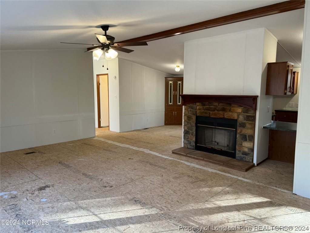 2352 County Line Road Cameron, NC 28326 - Photo 37 of 38 a living room with a fireplace and a ceiling fan